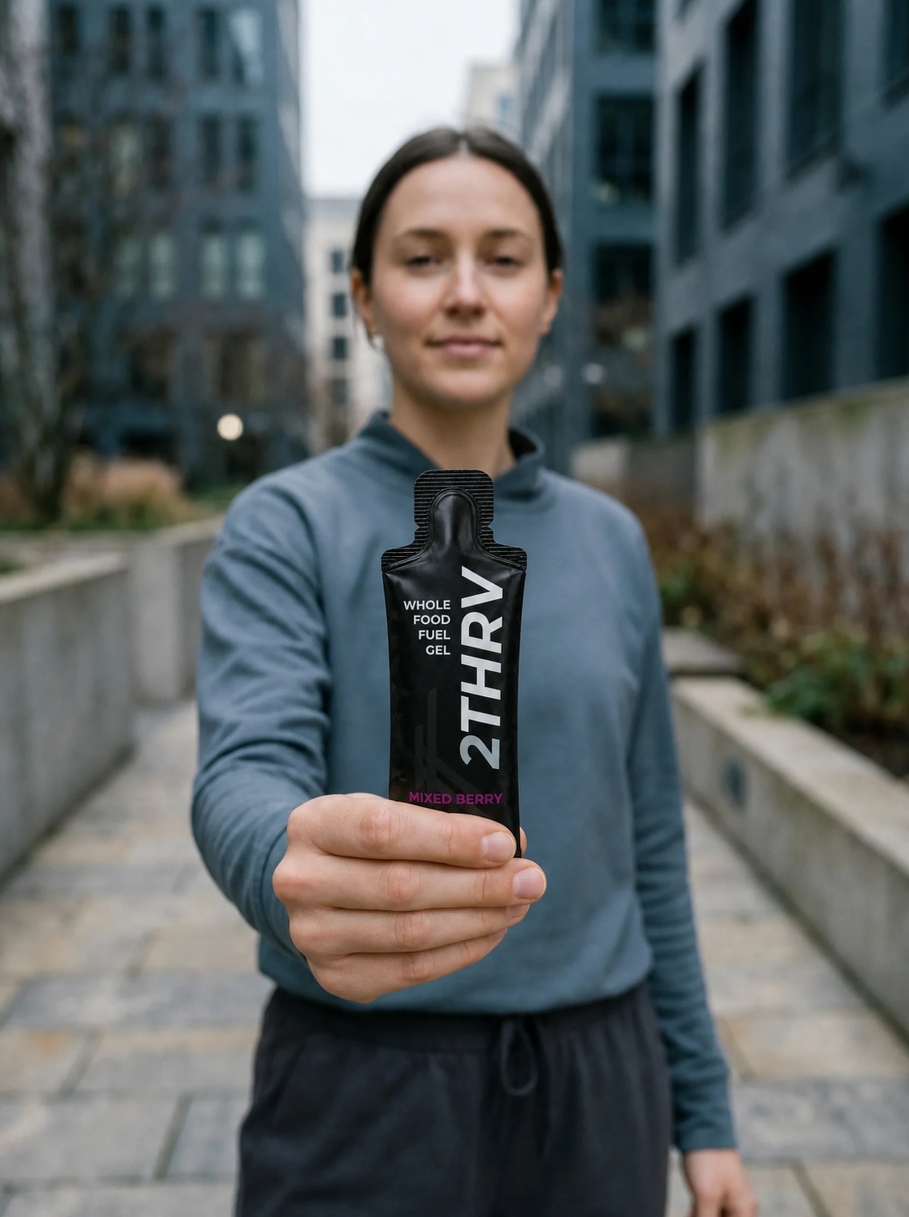 Runner holding a 2THRV natural whole-food energy gel pouch